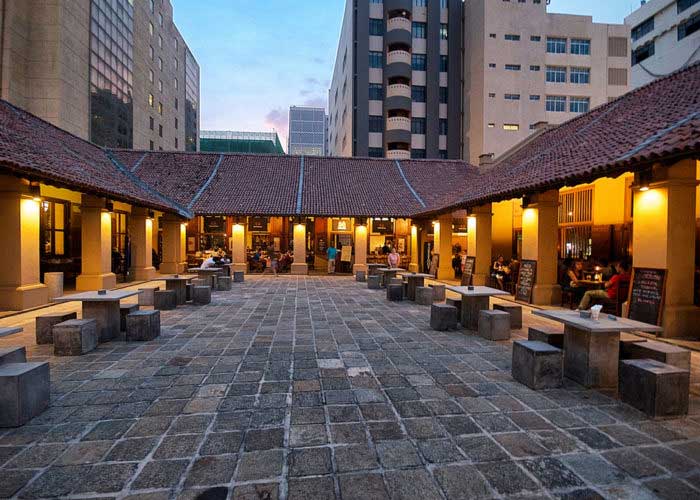 Relax and dine at the beautifully restored Dutch Hospital complex .